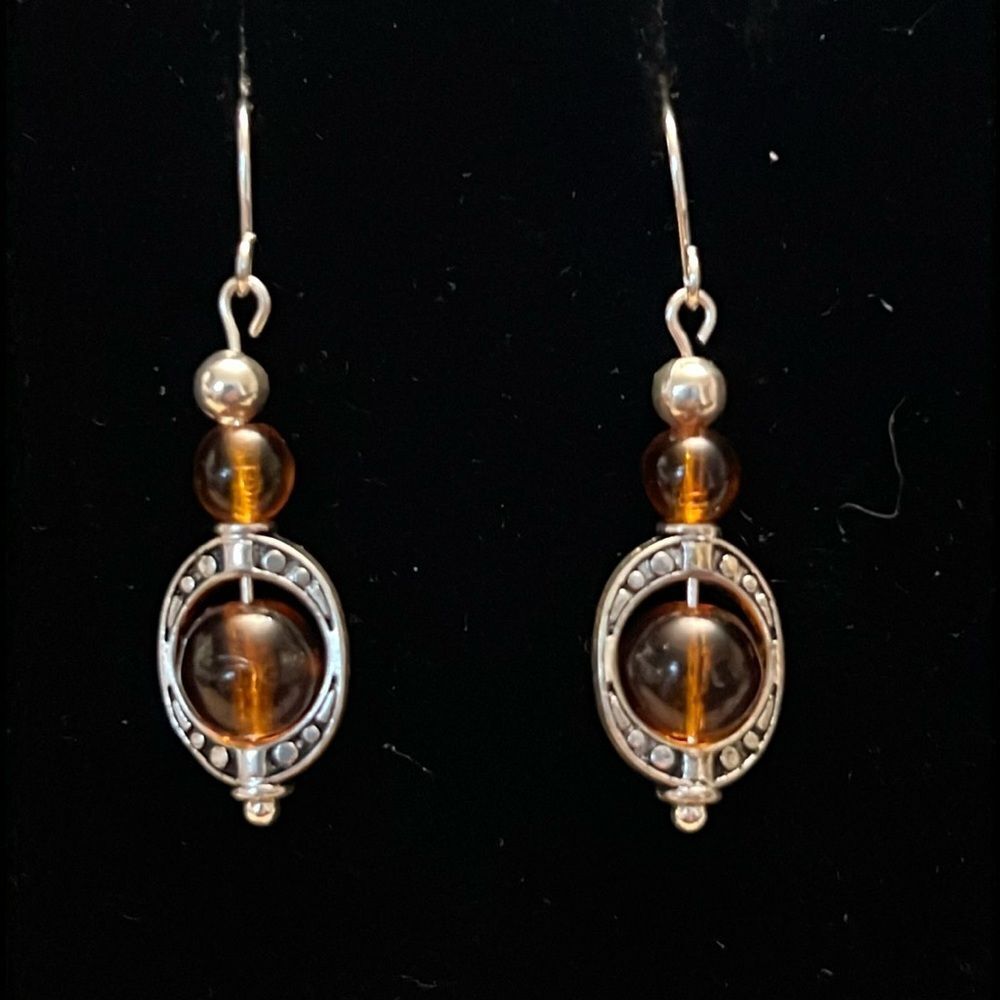 Handcrafted silver tone earrings with brown and silver beading.